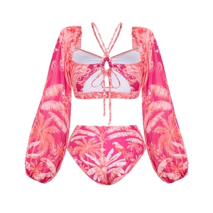 Detail of pink tropical print bikini set featuring long sleeves and lace-up back design