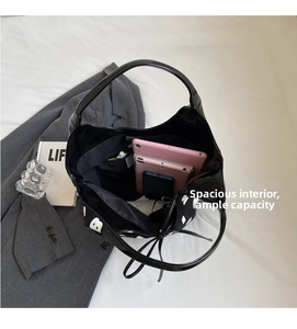 Macro shot showing the spacious interior of a black tote bag with white patterns