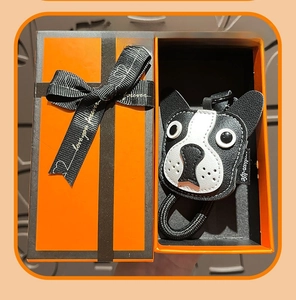 Close-up of leather bulldog keychain with hand-stitched detail in orange gift box
