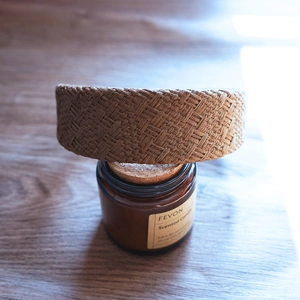 Close-up of brown woven raffia headband with vintage texture on a wooden surface