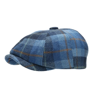 Classic blue plaid wool newsboy cap for autumn winter, side view on white background