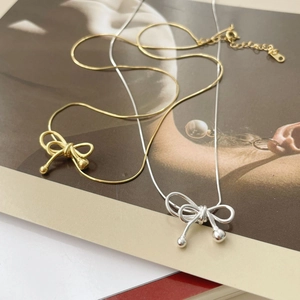 Elegant S925 silver bow pendant necklace available in gold and silver snake chain style