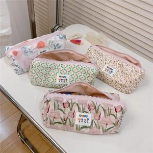 Detail showing four floral cotton fabric pouches with zipper closure and best logo patch
