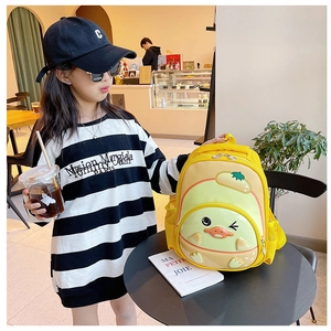 Cute yellow cartoon chick hard shell toddler backpack shown in a lifestyle cafe setting
