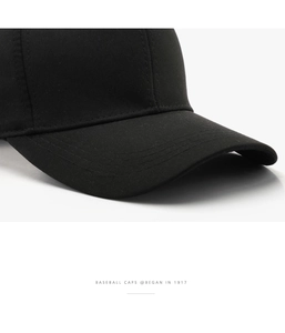 Close-up of black baseball cap showing premium twill fabric texture and durable stitching