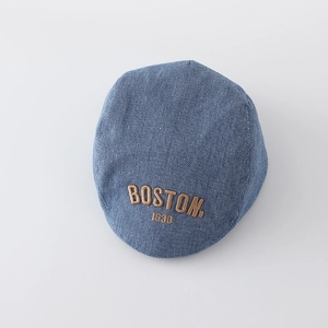 Detailed view of Boston 1630 thick embroidery on blue washed denim newsboy cap
