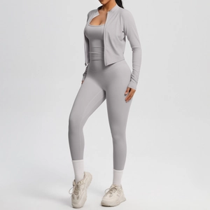 Detailed view of women's three-piece grey yoga set with zipper jacket and high waist leggings