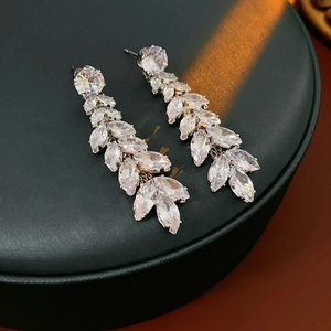 Macro shot of silver wheat ear tassel earrings with sparkling clear cubic zirconia stones