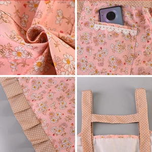 Pink daisy floral apron with beige polka dot pockets and elegant lace trim details