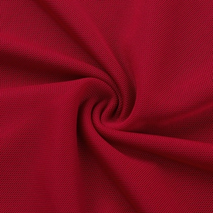 Close-up of deep red mesh fabric with fine honeycomb texture and soft draping effect