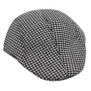 Detail of classic black and white houndstooth pattern fabric on a flat ivy cap