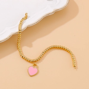 Beaded 18k gold plated stainless steel bracelet with a pink heart pendant for women