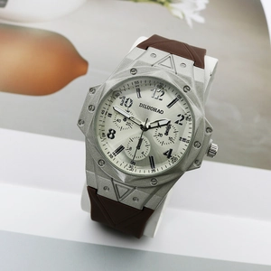 Close-up of industrial octagonal silver bezel and brown silicone strap on a quartz watch
