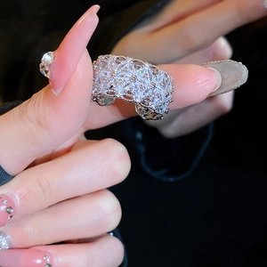 Detailed view of wide multi-layer silver ring with sparkling zircon stones on finger