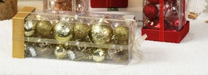 Detail of gold and red Christmas baubles with matte and glitter finishes in gift boxes