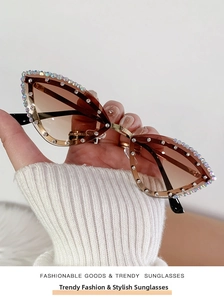 Detail of cat-eye sunglasses with gradient lenses and rhinestone-encrusted metal frames