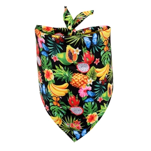 Detailed view of tropical fruit and floral patterns on black dog bandana fabric