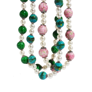 Multilayer pearl necklace with pink and green speckled glass beads on white background