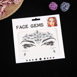 Symmetric clear face gems and rhinestones for music festivals on white backing card