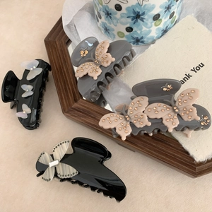 Set of four elegant acetate bow claw clips with rhinestones in grey and black finishes