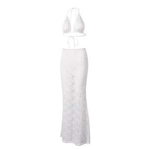 Detailed view of white floral lace texture on corset top and elegant maxi skirt set