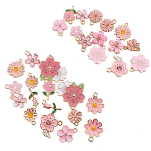 Detailed view of pink enamel cherry blossom pendants with gold plating and rhinestones