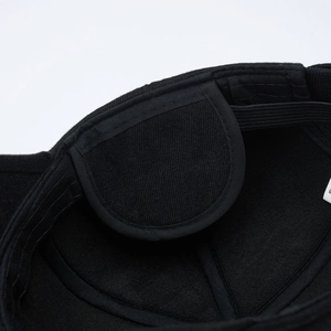 Macro detail of the black baseball cap interior showing sewing quality and size M label