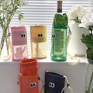 Detail of colorful mesh bottle bags with cute eye embroidery and adjustable straps