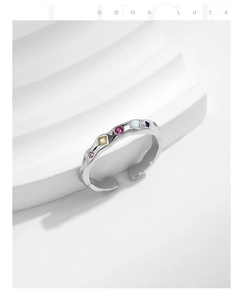 Detail of S925 sterling silver ring with irregular lava texture and colored zircon stones