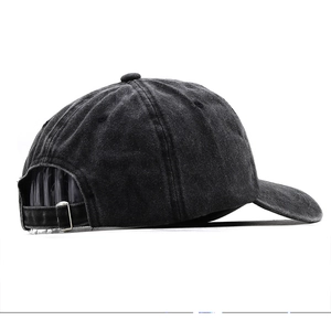 Detail view of adjustable metal buckle and washed denim texture on black baseball cap