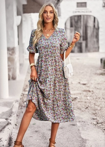 Detail shot of the V-neck and floral pattern on the blue A-line midi dress