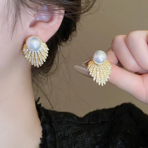 Elegant gold fan-shaped pearl earrings with sparkling zircon crystals shown on model