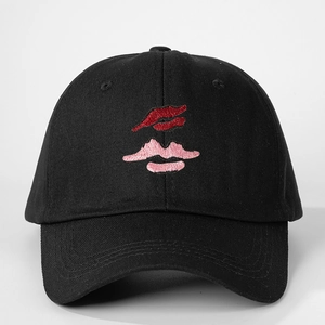 Classic black cotton baseball cap featuring detailed red and pink lip embroidery on front