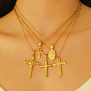 Cyberpunk layered gold cross necklaces with Ankh and oval pendants on model