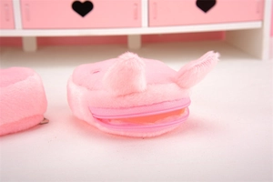 Detail of pink plush pig coin purse featuring soft texture and smooth zipper closure