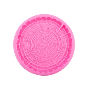 Round pink silicone mold for cake decorating featuring realistic wood stump grain texture