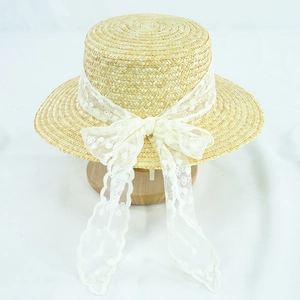 Elegant summer straw boater hat for women with a large white lace bow for sun protection