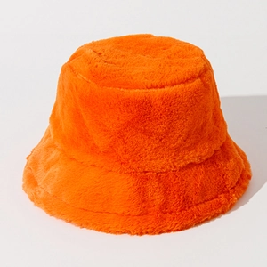 Detailed texture of vibrant orange faux fur on a warm winter bucket hat for women