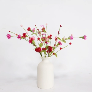 Artificial carnations with pink berries and red heart decor in a white ceramic vase
