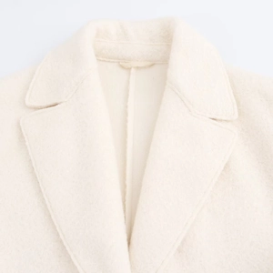 Elegant beige oversized wool coat featuring a classic notched lapel and soft texture