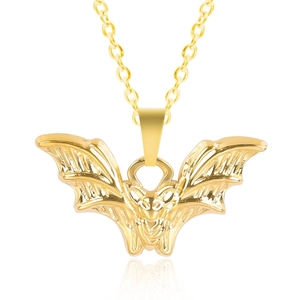 Detailed close-up of a 18K gold stainless steel bat pendant necklace with wings details