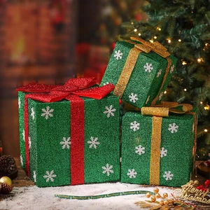 Three-piece green Christmas gift boxes with glitter red ribbons and snowflake patterns