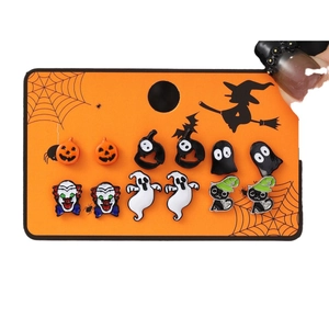 Halloween earring set featuring 6 pairs of pumpkin ghost and cat studs on a themed card