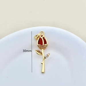 Detailed view of a 30mm golden rose pendant featuring a red stone and zircon accents