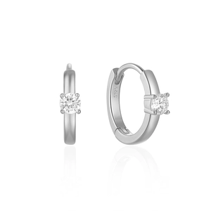 Macro detail of S925 sterling silver hoop earrings with classic four-claw set diamond