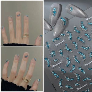 3D blue wave nail stickers with silver rhinestones on a professional grey background