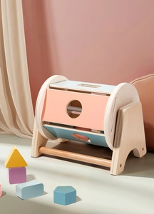 Detail of wooden shape rolling drum with geometric blocks in pastel Morandi colors