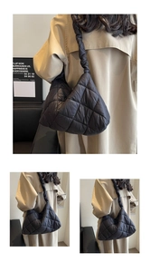 Detailed view of black quilted puff tote with ruffled strap and diamond lattice pattern