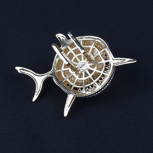 Gold-plated hollow-out shark pendant on cuban tennis chain against a black background