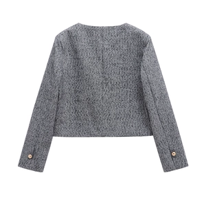 Detail view of herringbone tweed jacket back featuring metallic buttons on cuffs